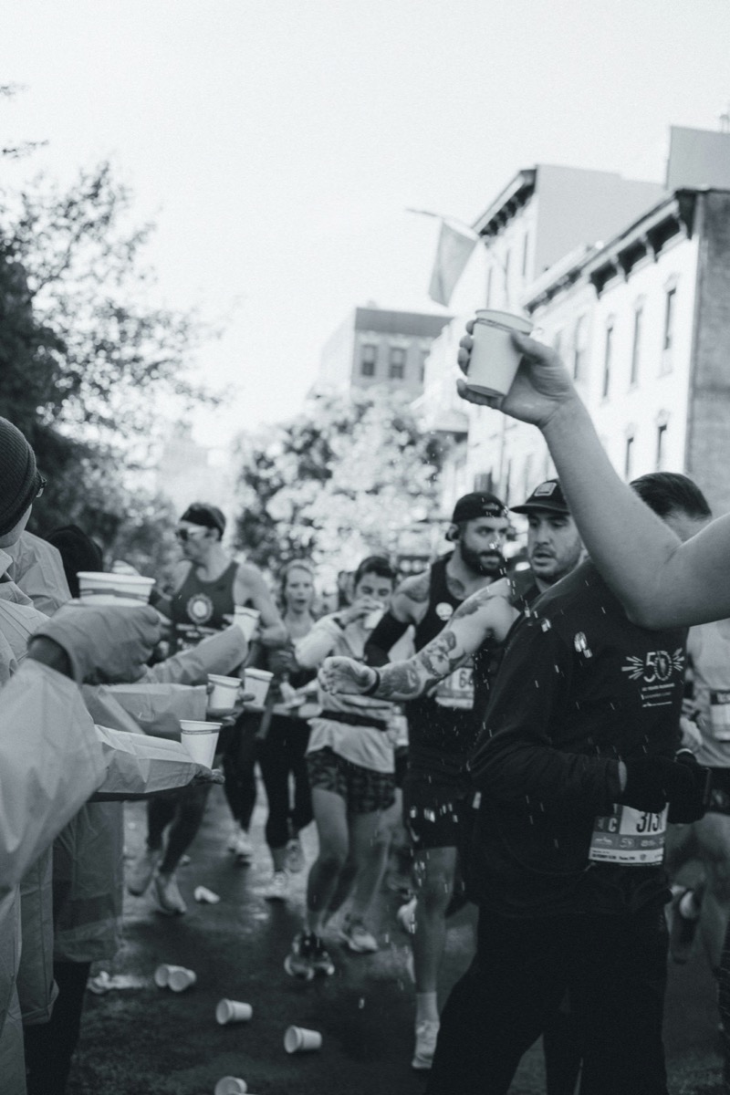 Spectators handing water to runners on race day